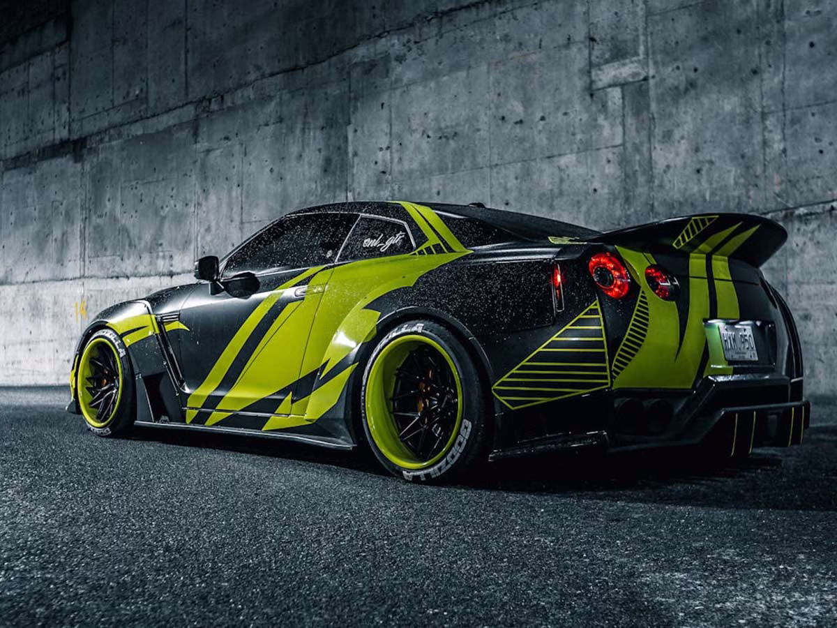 The Nissan GT-R supercar displays a dynamic car wrap and sleek lines, showcasing its design for speed and agility.